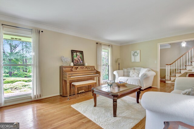 115 Shoal Creek Dr, Sharpsburg, GA 30277 - living room featuring stairs, light wood finished floors, and crown molding
