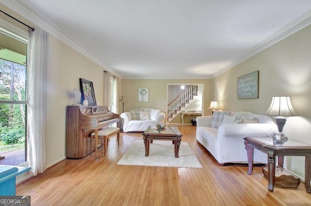 115 Shoal Creek Dr, Sharpsburg, GA 30277 - living area with ornamental molding, light wood-style flooring, and stairway