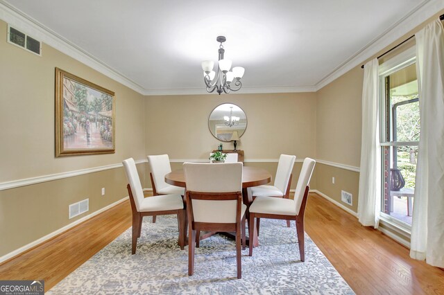 115 Shoal Creek Dr, Sharpsburg, GA 30277 - dining space with a chandelier, light wood-style floors, and ornamental molding
