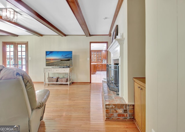 115 Shoal Creek Dr, Sharpsburg, GA 30277 - living area with beamed ceiling, a fireplace, and light wood finished floors