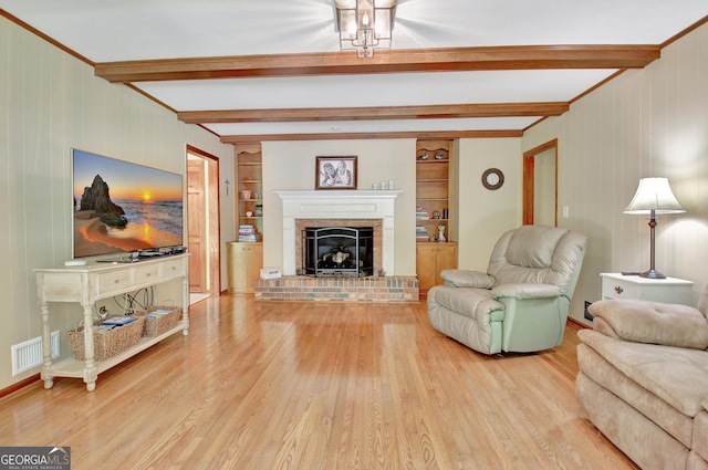 115 Shoal Creek Dr, Sharpsburg, GA 30277 - living area featuring beam ceiling, wood finished floors, a brick fireplace, built in shelves, and wooden walls