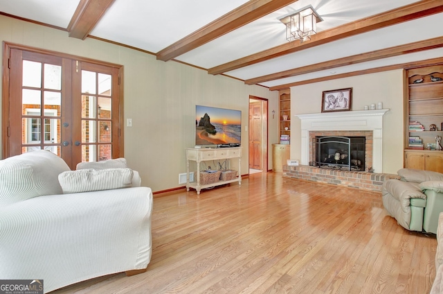 115 Shoal Creek Dr, Sharpsburg, GA 30277 - living area with beam ceiling, light wood-type flooring, a fireplace, and french doors
