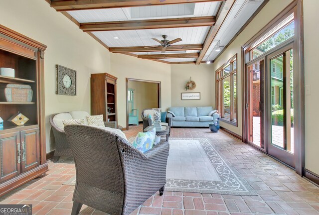 115 Shoal Creek Dr, Sharpsburg, GA 30277 - living room with beamed ceiling, ceiling fan, and brick floors