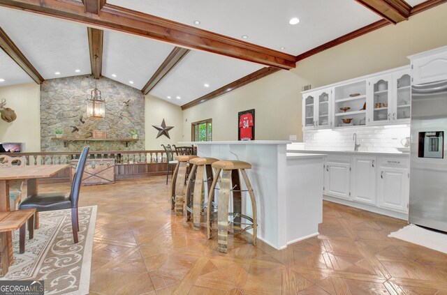 115 Shoal Creek Dr, Sharpsburg, GA 30277 - kitchen with stainless steel refrigerator with ice dispenser, white cabinetry, glass insert cabinets, light countertops, and backsplash