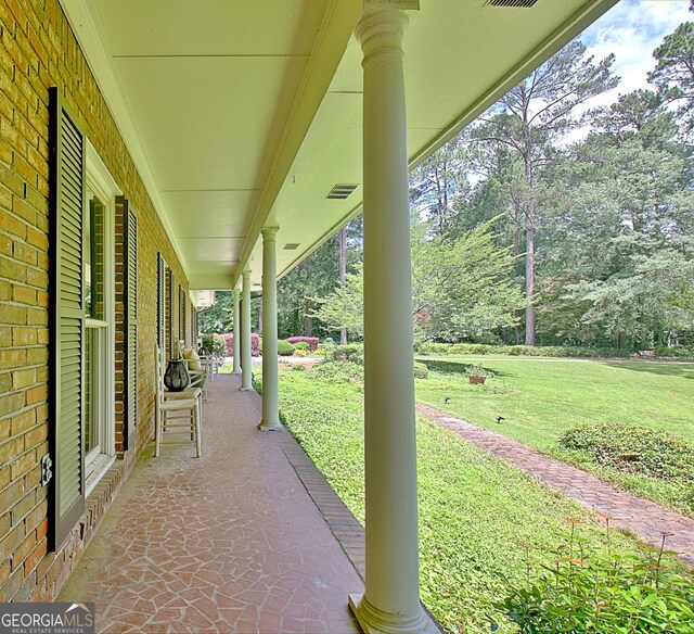 115 Shoal Creek Dr, Sharpsburg, GA 30277 - porch with a lawn and view of scattered trees