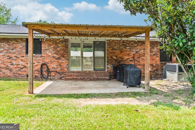 1508 Windsor Rd, Perry, GA 31069 - rear view of property with a patio area, a yard, and brick siding