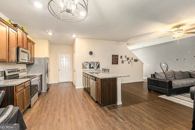 3350 Clawing Hawk Way, Douglasville, GA 30135 - kitchen with stainless steel appliances, open floor plan, dark wood-style flooring, and ceiling fan