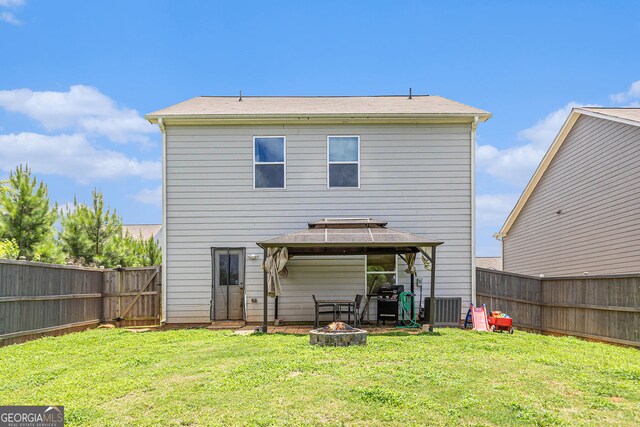 3350 Clawing Hawk Way, Douglasville, GA 30135 - back of house with a gazebo, a fire pit, a fenced backyard, and a gate