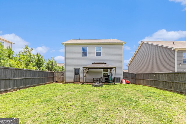3350 Clawing Hawk Way, Douglasville, GA 30135 - back of house with a gazebo, a fire pit, and a fenced backyard