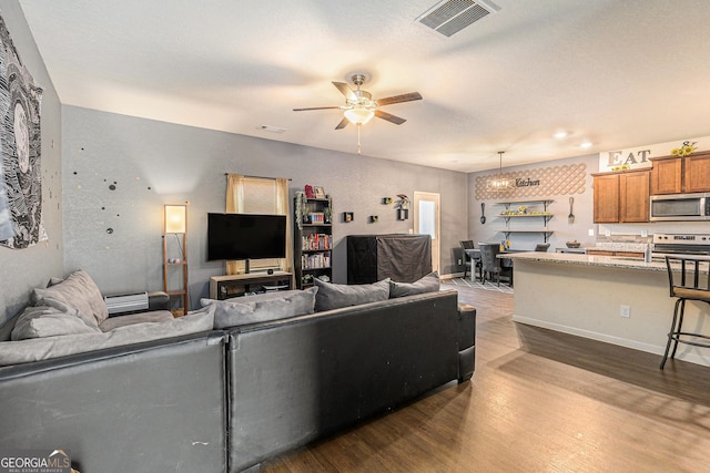 3350 Clawing Hawk Way, Douglasville, GA 30135 - living area featuring a ceiling fan and dark wood-type flooring