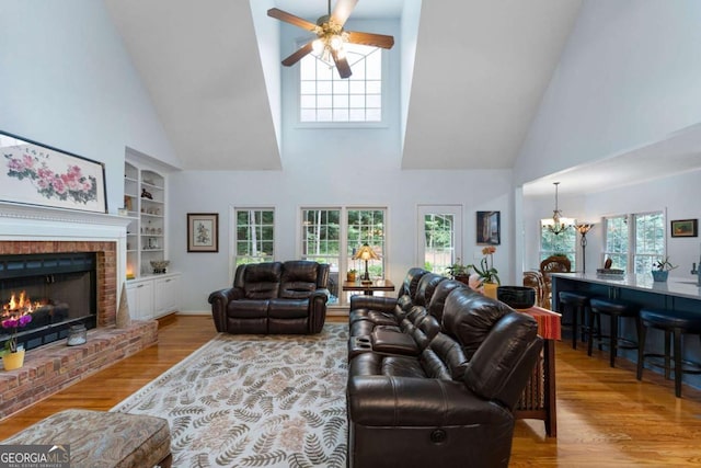 17 Shotgun Rd NW, Cartersville, GA 30121 - living area featuring high vaulted ceiling, a chandelier, wood finished floors, a ceiling fan, and built in features