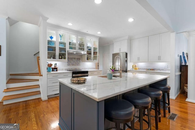 17 Shotgun Rd NW, Cartersville, GA 30121 - kitchen featuring white cabinetry, backsplash, a kitchen island with sink, and recessed lighting
