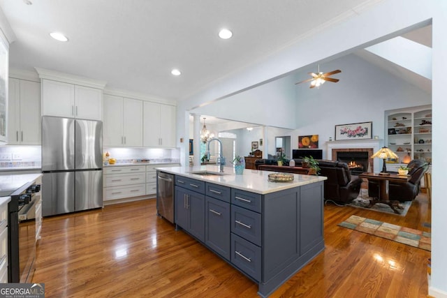 17 Shotgun Rd NW, Cartersville, GA 30121 - kitchen featuring appliances with stainless steel finishes, white cabinetry, a fireplace, light countertops, and a ceiling fan