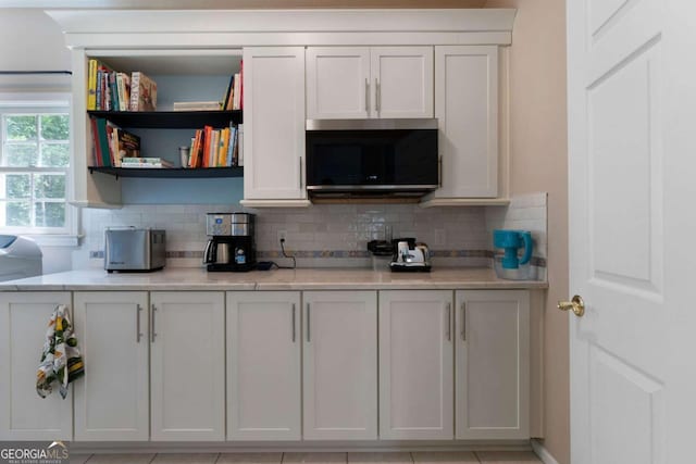 17 Shotgun Rd NW, Cartersville, GA 30121 - kitchen featuring stainless steel microwave, light countertops, backsplash, and open shelves