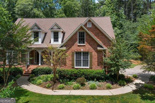 17 Shotgun Rd NW, Cartersville, GA 30121 - view of front of home featuring covered porch, brick siding, and roof with shingles