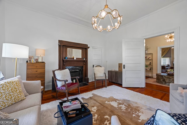 514 S Jefferson St, Washington, GA 30673 - living room featuring crown molding, a chandelier, and wood finished floors