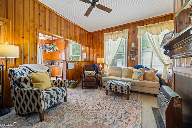 514 S Jefferson St, Washington, GA 30673 - carpeted living room with ceiling fan, wood walls, heating unit, and vaulted ceiling