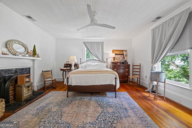 514 S Jefferson St, Washington, GA 30673 - bedroom featuring wood finished floors, a wood stove, wooden ceiling, ornamental molding, and a ceiling fan