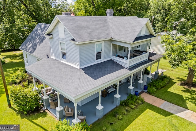 514 S Jefferson St, Washington, GA 30673 - view of front facade featuring a patio, a front yard, a balcony, and a chimney