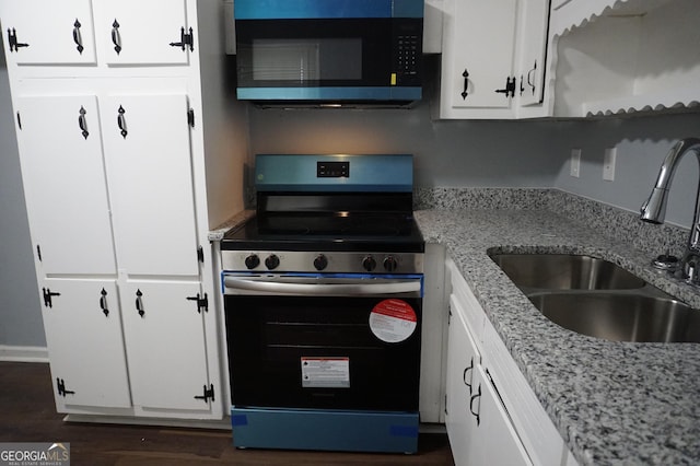 39 Mcferrin Cir, Riverdale, GA 30274 - kitchen with appliances with stainless steel finishes, white cabinetry, dark wood-type flooring, and light stone countertops