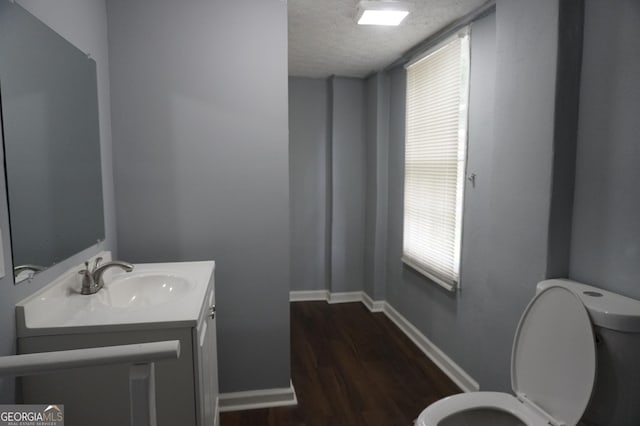 39 Mcferrin Cir, Riverdale, GA 30274 - half bath with vanity, wood finished floors, a textured ceiling, and healthy amount of natural light