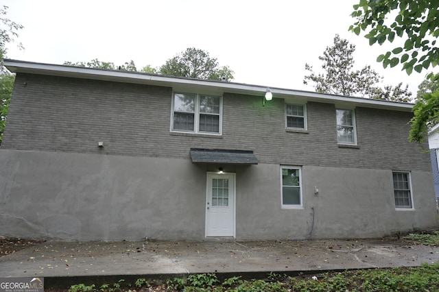39 Mcferrin Cir, Riverdale, GA 30274 - back of property with stucco siding, brick siding, and a patio