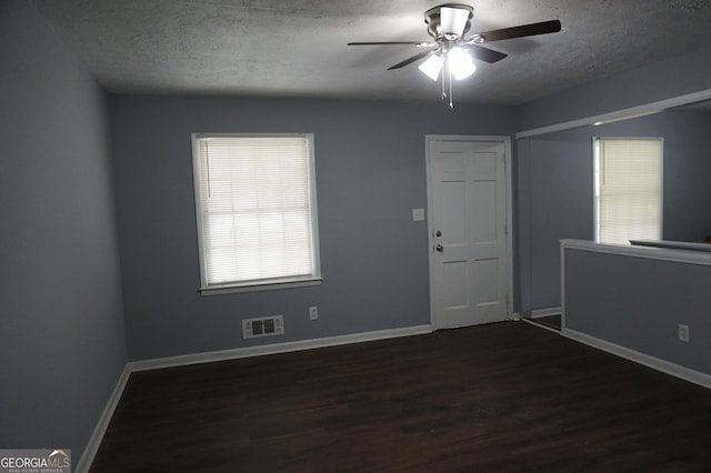 39 Mcferrin Cir, Riverdale, GA 30274 - unfurnished room featuring a textured ceiling, ceiling fan, and dark wood-type flooring