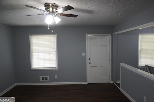 39 Mcferrin Cir, Riverdale, GA 30274 - foyer entrance featuring a textured ceiling, dark wood finished floors, and a ceiling fan
