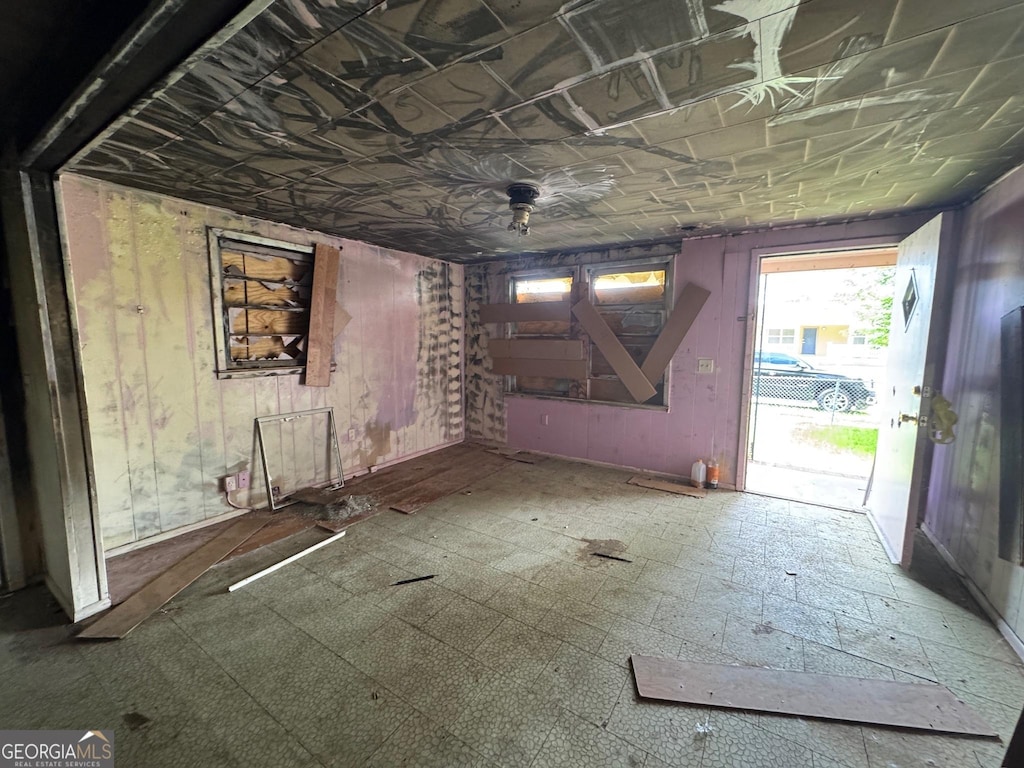 303 Hudson St, Dublin, GA 31021 - unfurnished living room with an ornate ceiling and wood walls