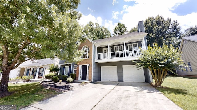 3157 Peartree Dr NW, Acworth, GA 30101 - view of front of property featuring an attached garage, concrete driveway, a balcony, a chimney, and a front yard