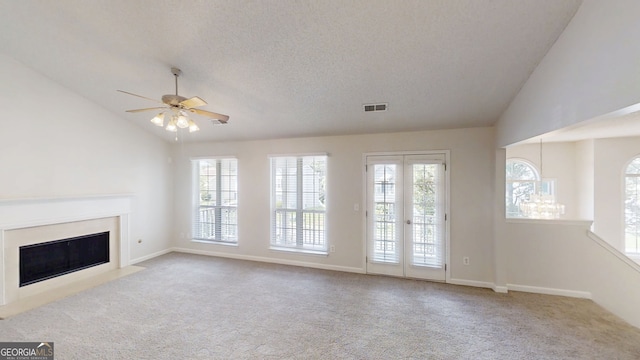 3157 Peartree Dr NW, Acworth, GA 30101 - unfurnished living room with lofted ceiling, carpet floors, a fireplace with flush hearth, ceiling fan, and a textured ceiling