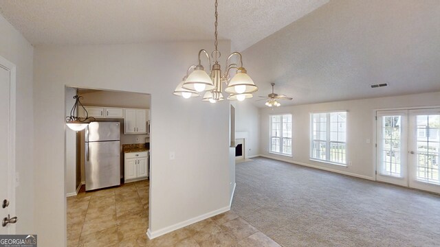 3157 Peartree Dr NW, Acworth, GA 30101 - kitchen featuring freestanding refrigerator, a textured ceiling, a chandelier, a ceiling fan, and white cabinets