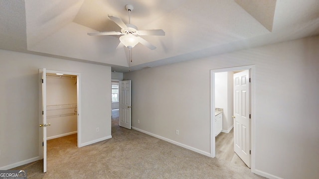 3157 Peartree Dr NW, Acworth, GA 30101 - unfurnished bedroom featuring a walk in closet, light colored carpet, a closet, ceiling fan, and connected bathroom