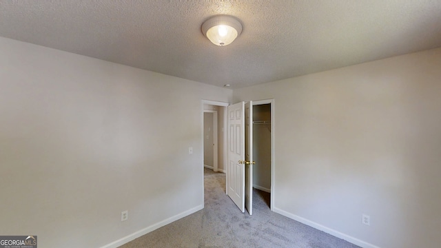 3157 Peartree Dr NW, Acworth, GA 30101 - unfurnished bedroom with carpet flooring, a textured ceiling, and a closet