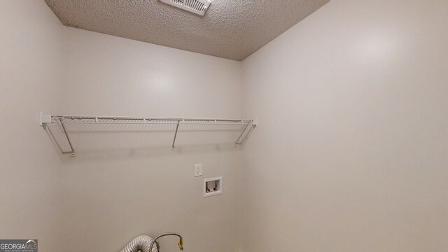 3157 Peartree Dr NW, Acworth, GA 30101 - laundry room featuring hookup for a washing machine and a textured ceiling