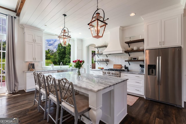 2816 Oconee Springs Dr, Statham, GA 30666 - kitchen featuring stainless steel appliances, open shelves, premium range hood, dark wood finished floors, and recessed lighting