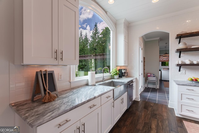 2816 Oconee Springs Dr, Statham, GA 30666 - kitchen with open shelves, arched walkways, crown molding, light stone counters, and decorative backsplash