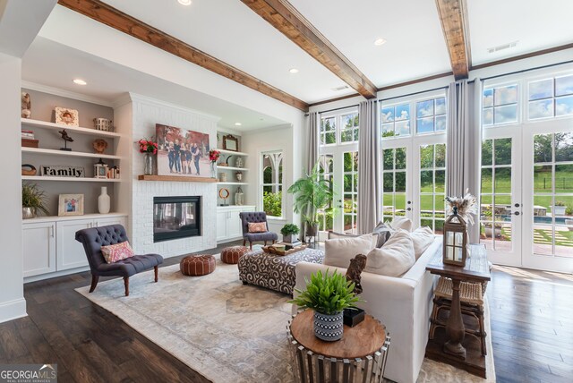 2816 Oconee Springs Dr, Statham, GA 30666 - living area featuring dark wood finished floors, plenty of natural light, a large fireplace, crown molding, and beamed ceiling