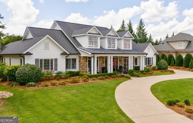 2816 Oconee Springs Dr, Statham, GA 30666 - view of front of house with a standing seam roof, a front yard, a metal roof, and stone siding