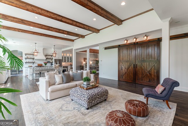 2816 Oconee Springs Dr, Statham, GA 30666 - living room featuring a barn door, recessed lighting, wood finished floors, beam ceiling, and arched walkways