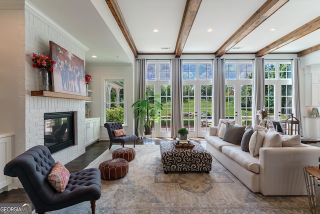 2816 Oconee Springs Dr, Statham, GA 30666 - living area with a brick fireplace, beam ceiling, wood finished floors, crown molding, and french doors