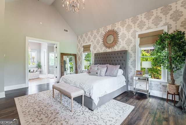 2816 Oconee Springs Dr, Statham, GA 30666 - bedroom featuring a chandelier, wallpapered walls, dark wood-type flooring, high vaulted ceiling, and ensuite bath
