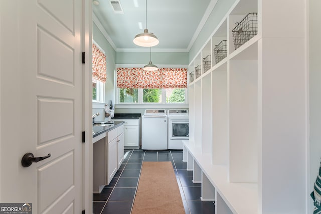 2816 Oconee Springs Dr, Statham, GA 30666 - mudroom with washing machine and clothes dryer, crown molding, and dark tile patterned floors