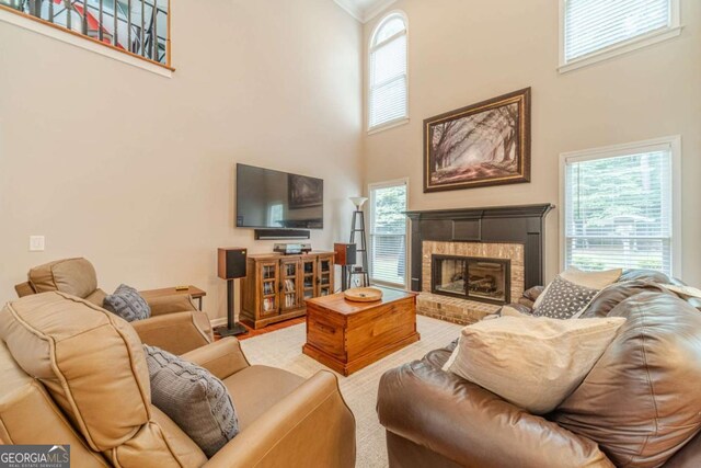 1461 Radstone Dr, Lawrenceville, GA 30044 - living area with a high ceiling, a fireplace, plenty of natural light, and ornamental molding