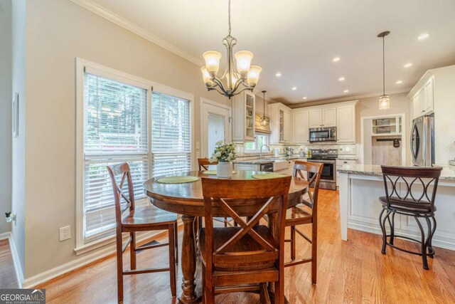 1461 Radstone Dr, Lawrenceville, GA 30044 - dining room featuring ornamental molding, light wood-style floors, a chandelier, and recessed lighting