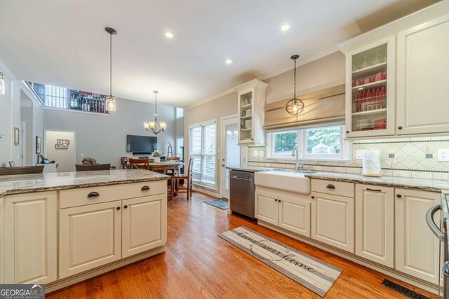 1461 Radstone Dr, Lawrenceville, GA 30044 - kitchen with dishwasher, decorative backsplash, hanging light fixtures, light wood-type flooring, and recessed lighting