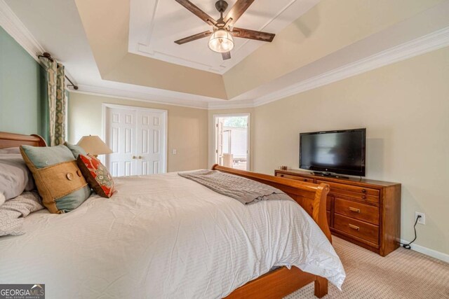 1461 Radstone Dr, Lawrenceville, GA 30044 - bedroom featuring light carpet, a raised ceiling, a ceiling fan, and ornamental molding
