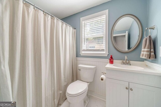 1461 Radstone Dr, Lawrenceville, GA 30044 - bathroom with vanity, marble finish flooring, and a wainscoted wall