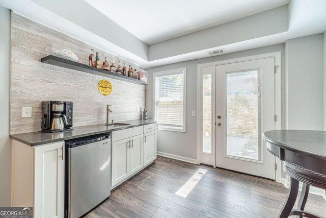 1461 Radstone Dr, Lawrenceville, GA 30044 - indoor wet bar with dishwasher, light wood-type flooring, and decorative backsplash