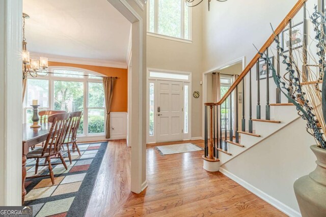 1461 Radstone Dr, Lawrenceville, GA 30044 - entryway with a chandelier, wood finished floors, stairway, and ornamental molding